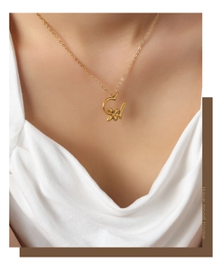 Close-up of a gold-plated flower pendant necklace on a model for elegant jewelry styling