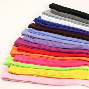 Detailed close-up showing vibrant multi-color ribbed knit slouch socks in a stacked arrangement