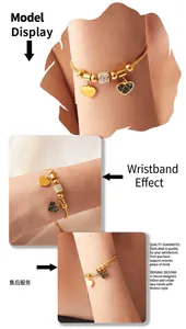 Detail of 18K gold snake chain bracelet with colorful crystal heart charms on wrist