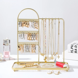 Golden iron jewelry organizer with three-tier earring rack and glass base tray