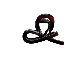 Glossy amber-patterned bow hair claw clip in deep brown for delicate half-up hairstyles