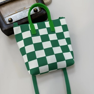 Detail of green and white checkerboard knit tote bag with retro radio prop background