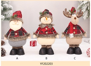 Detailed view of Santa, snowman and reindeer plush toys on decorative snow background
