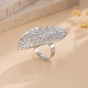 Macro detail of silver leaf ring featuring hollowed textures and adjustable open band