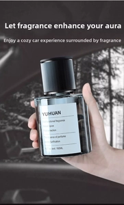 Person holding a 160ml dark grey glass bottle of YUHUAN automotive aromatherapy oil
