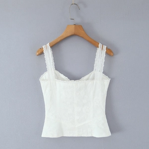 Close-up of white lace camisole featuring detailed 3D floral embroidery and square neck