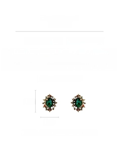 Detail view of vintage emerald green resin earrings with faux pearls and enamel accents