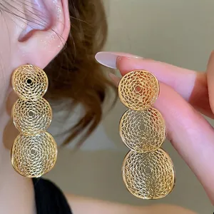 Elegant gold-tone geometric hollow round drop earrings featuring metallic mesh texture