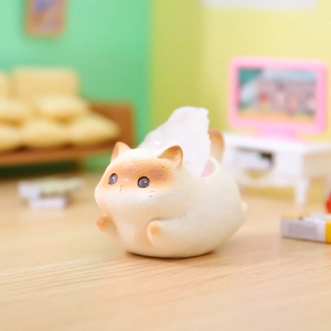 Close-up of a cute cartoon cat-shaped resin tissue box in a cozy miniature home scene