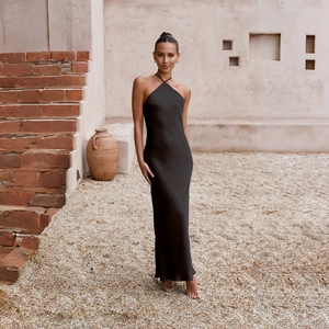 Close-up of black backless halter neck satin maxi dress with sleek slim-fit silhouette