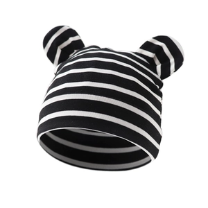 Detail of soft black and white striped cotton knit baby hat with cute bear ears