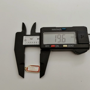 Digital caliper measuring the 19.6mm Merry Christmas enamel tree charm pendant