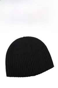 Macro detail of black knit beanie showing vertical ribbed texture and elastic warm fabric