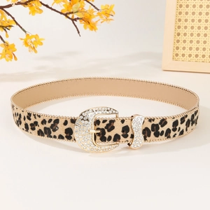 Leopard print leather belt with sparkling rhinestone buckle on a neutral backdrop