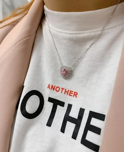Close-up of 925 sterling silver necklace with pink heart-cut stone on a model
