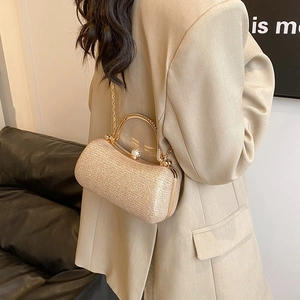 Elegant champagne gold glitter clutch with metal ring handle and crossbody chain strap