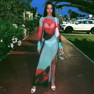 Détail d'une robe maxi transparente en mesh à imprimé rouge et bleu avec fente haute