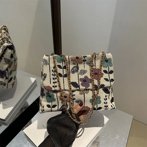 Floral embroidered chain shoulder bag in beige with colorful patterns and gold strap