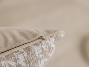 Detail of hidden zipper and beige jacquard velvet texture on minimalist luxury cushion cover