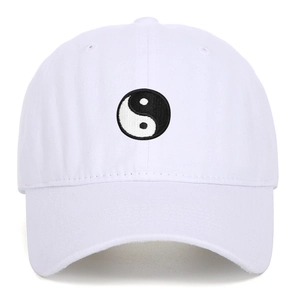 White cotton baseball cap featuring embroidered Tai Chi Yin Yang symbol in front view