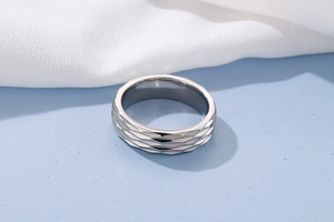 Macro detail of silver titanium steel ring with elegant quilted lattice pattern