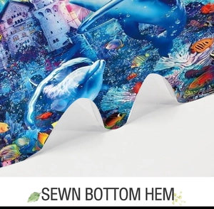 Detail of sewn bottom hem on ocean themed shower curtain with sea creatures