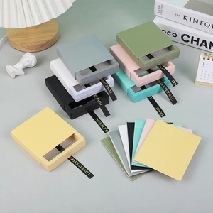 Colorful slide-out jewelry gift boxes with satin ribbons displayed in a modern lifestyle setting