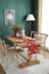 Close-up of a festive red table runner featuring white snowflake patterns for Christmas