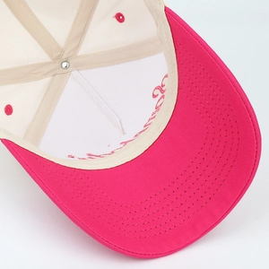 Detailed macro view of the pink letter embroidery and reinforced stitching on the cap
