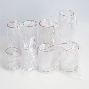 Set of clear acrylic striped cylinder candle molds in various sizes on white background