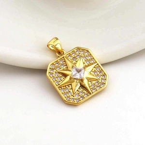 Macro view of gold octagon star pendant featuring micro-pave cubic zirconia crystals