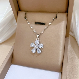 Macro shot of silver flower pendant with teardrop zircon stones on a chain in a jewelry box