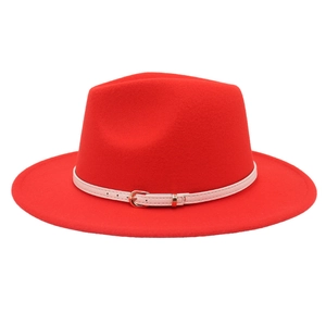 Detail of red wool felt fedora featuring a slim white leather belt with gold metal buckle