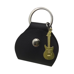 Detail of black leather guitar pick pouch with silver ring buckle and gold guitar charm