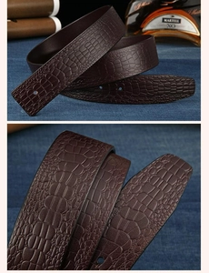 Detail of dark brown leather belt with embossed crocodile texture in a business setting