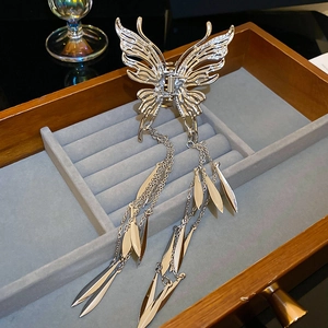 Detail of silver butterfly hair claw with long tassel chains and metallic charms