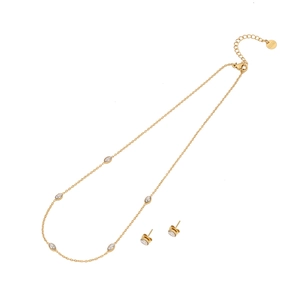 Gold stainless steel heart necklace and stud earrings set with clear crystals on white