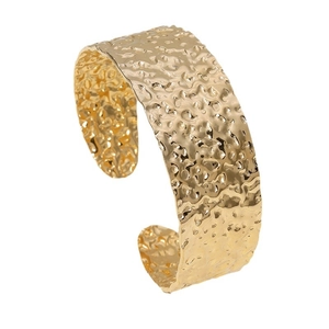 Minimalist wide golden stainless steel bangle with a hammered texture and open design