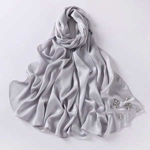 Close-up of silver-grey chiffon hijab scarf featuring elegant floral rhinestone patterns
