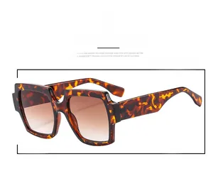 Detail of tortoise shell square oversized sunglasses with brown gradient lenses