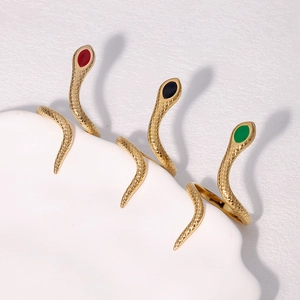 Detail view of gold snake rings with scales and red black green stone accents