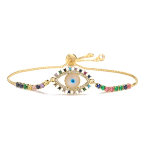 Macro detail of gold adjustable evil eye bracelet with colorful zircon pavé stones