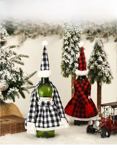 Close-up of Christmas wine bottle covers with red and black plaid scarves and hats