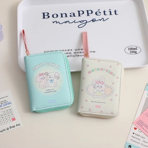 Detailed view of mint green and cream white PU leather coin purses with cute cartoons
