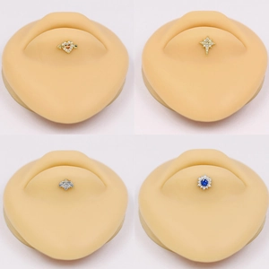 Surgical steel lip stud jewelry set with heart, star, and clover designs in gold and silver