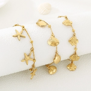 Detailed shot of gold stainless steel anklets featuring starfish and seashell pendants