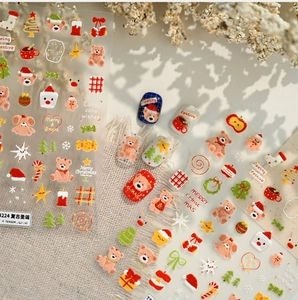 Detail of Christmas nail art stickers featuring vintage bears and holiday motifs