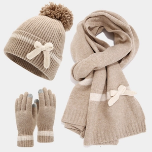 Winter knit set featuring a ribbed hat with pompom, long scarf, and touchscreen gloves