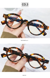 Detailed views of vintage tortoiseshell round eyeglass frames with marble background