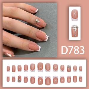 Classic French nude pink press-on nails with white tips, rhinestones and 24pc set display